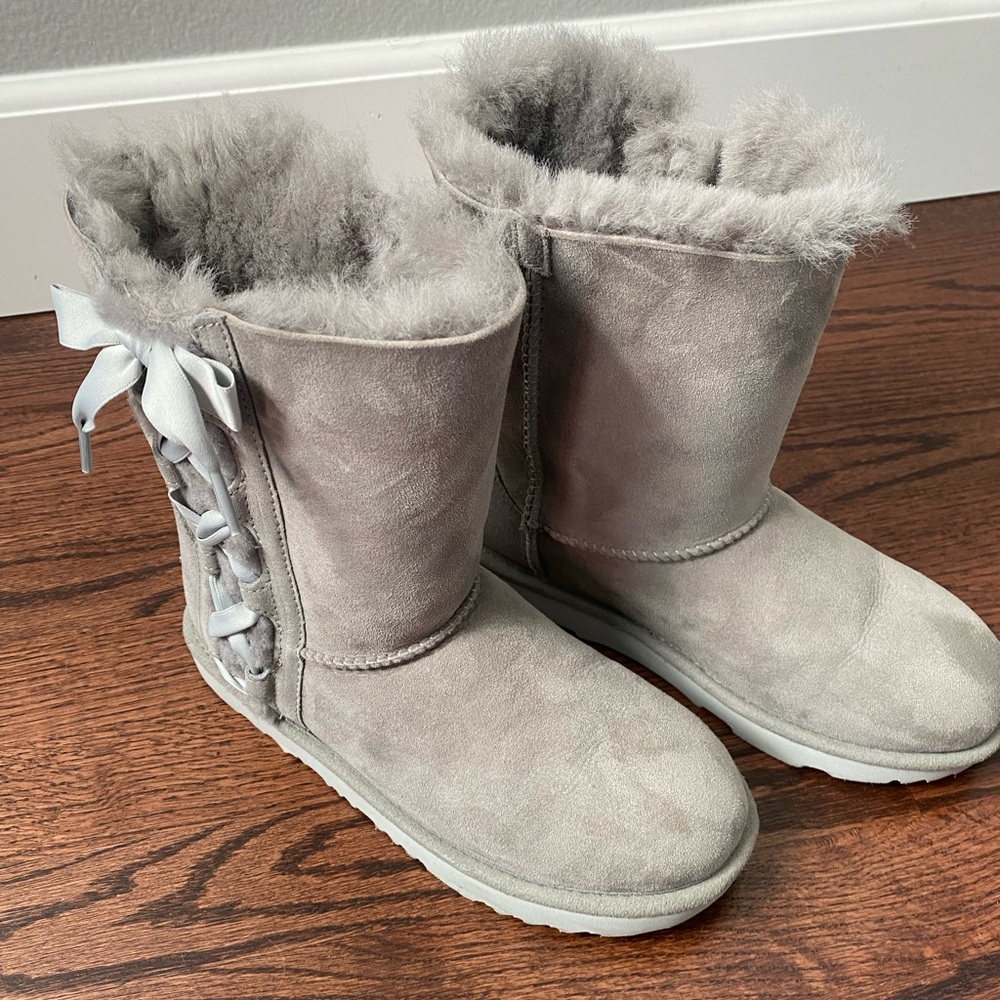 Excellent condition girl Uggs in beautiful gray with side satin ribbon & bow.